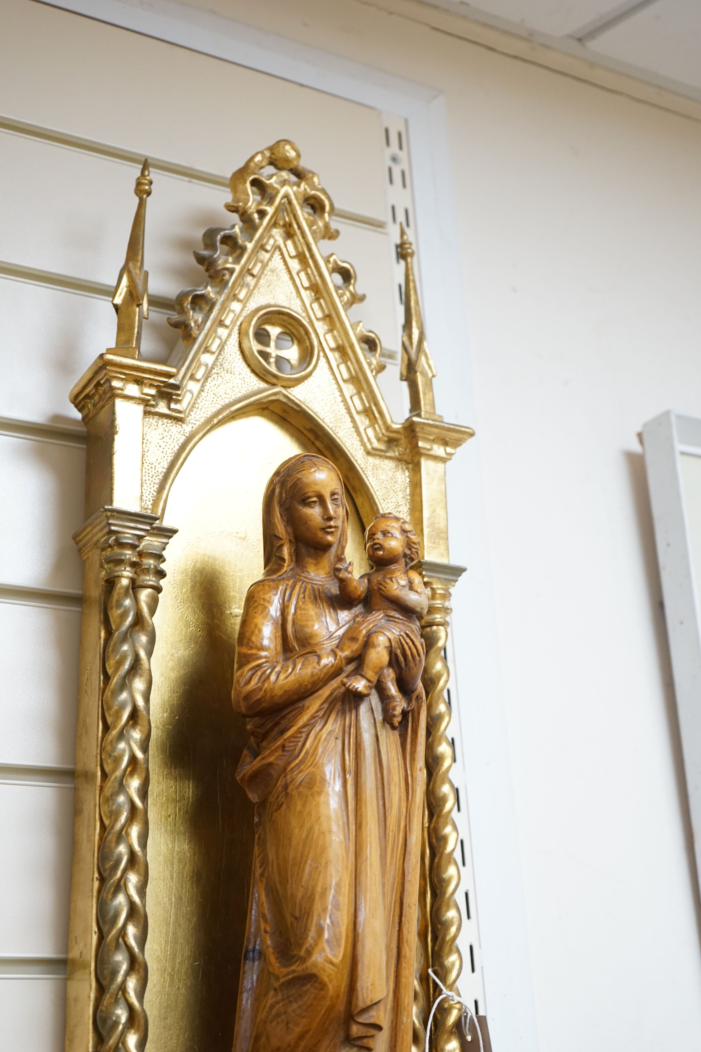 A 19th century architectural gilt niche and a 20th century carved pine group of Madonna and child 88cm